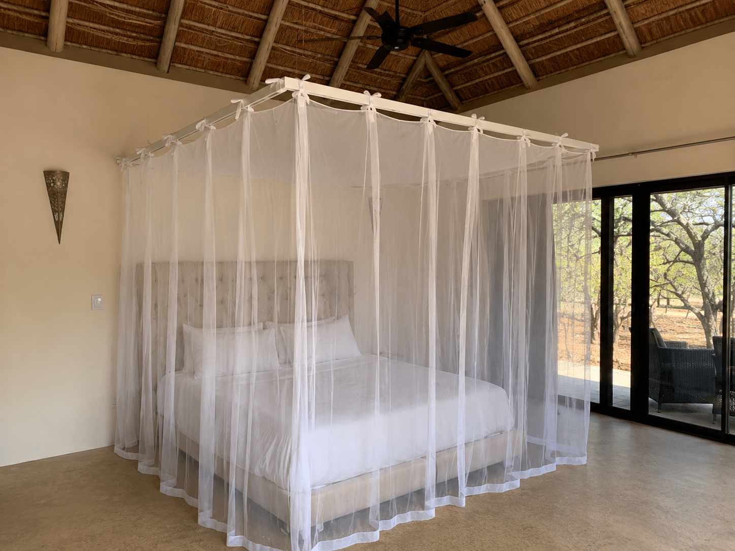 Custom mosquito net canopy over a king bed